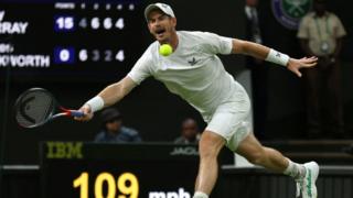 still shows andy murray launching towards a tennis ball with his racket raised