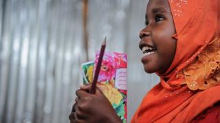 A displaced Somali girl attends a class at a makeshift school at the Badbado IDP camp in Mogadishu, Somalia - 25 June 2018