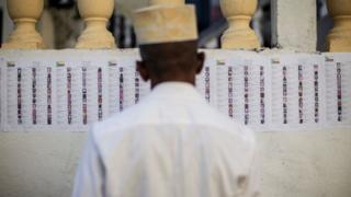 A man checks the voters lists ahead on March 24, 2019 in Moroni.