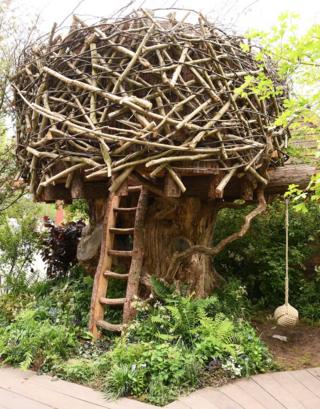 A treehouse in the Back to Nature Garden at Chelsea Flower Show