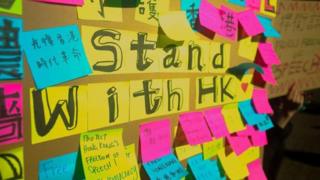 Messages of support on post-it notes stuck on a poster board
