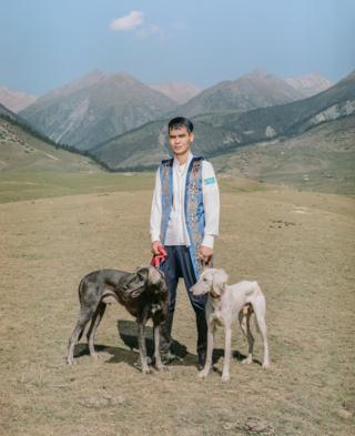 A man poses with dogs