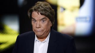 Embattled tycoon Bernard Tapie poses before a broadcasted debate on French news channel iTele on July 10, 2013 in Paris