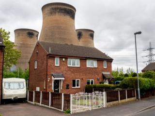 Houses situated in close proximity to the cooling towers at Ferrybridge Power Station. Knottingley, West Yorkshire.