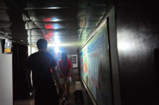 Walking down the low ceiling 5th floor corridor