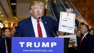 US presidential hopeful Donald Trump holds up a signed pledge during a press availability at Trump Tower in Manhattan, New York on 3 September 2015.