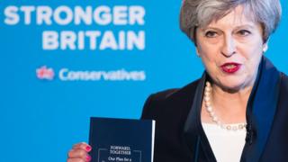 Theresa May holding the Conservative Party manifesto