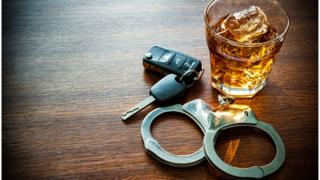 Drink, car keys, handcuffs