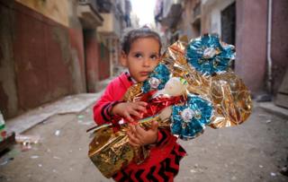 Habiba, 6, hugs Aroset El Moulid or (Bride of Moulid) traditional sugar candy in the shape of dolls, in preparation for the celebration Prophet Muhammad"s birthday, in Tanta, north of Cairo, Egypt November 24, 2017. Picture taken November 24, 2017.