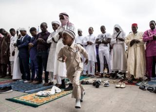 A young Muslim worshipper runs off during a mass prayer to celebrate Eid al-Fitr at the Stade des Martyrs in Kinshasa, DR Congo - 4 June 2019