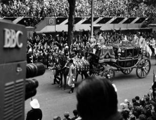 The carriage procession of H.M. Queen Elizabeth the Queen Mother and H.R.H. the Princess Margaret passing the television camera on the Victoria Embankment on the way to the Abbey. This image is taken from the Coronation of Her Majesty (H.M), Queen Elizabeth II (Queen Elizabeth The Second), June 2nd 1953.
