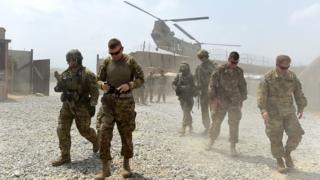 US army soldiers walk as a Nato helicopter flies overhead at coalition force Forward Operating Base (FOB) Connelly in the Khogyani district in the eastern province of Nangarhar, Afghanistan (2015 file picture)