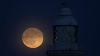 Wolf moon seen over St Mary's lighthouse at Whitley Bay in Northumberland