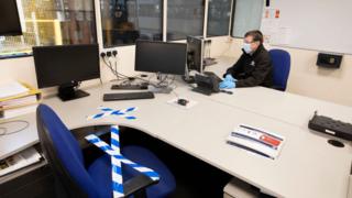 Chair is taped up in office where man works