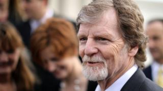Conservative Christian baker Jack Phillips talks with journalists in front of the Supreme Court