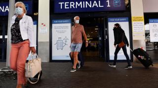 People at Manchester airport wearing masks