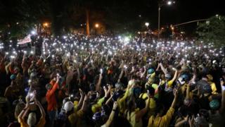 As part of a peaceful demonstration in the city on Monday evening, thousands of protesters walked through the streets holding aloft lit mobile phones