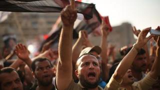 Pro Mohamed Morsi supporters rally near where over 50 were purported to have been killed by members of the Egyptian military and police in early morning clashes on July 8, 2013 in Cairo, Egypt.