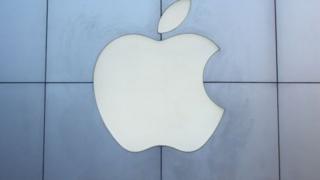 People stand in front of an Apple store in China