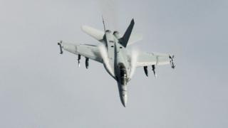 An airstrike which reportedly killed dozens of Syrian government troops has raised tensions between the US and Russia