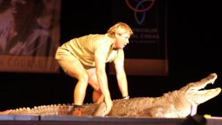 Steve Irwin with a crocodile on stage