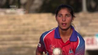 Woman bowling a cricket ball