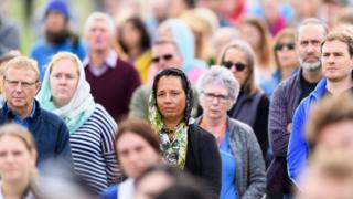 Members of the public react during the National Remembrance Service on 29 March