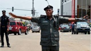 A policeman stretched his arms to stop protesters advancing to a barricade in Port Harcourt, Rivers State, on March 11, 2019.