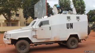 UN peacekeeping soldiers from Rwanda patrol on December 09, 2014 in Bangui.