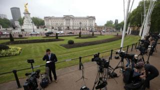 Crews outside Buckingham Palace