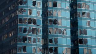 A high-rise Hong Kong building has dozens of smashed windows