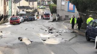 A burst water main in a street