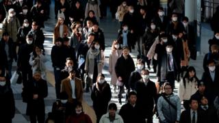 Commuters walk on concourse at a railway's terminal station in Tokyo on January 31, 2020.