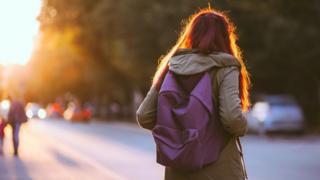 Teenager wearing school bag