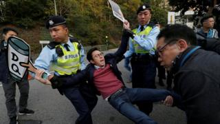 A pro-democracy protester against the disqualification of lawmakers is taken away by the police before Hong Kong Chief Executive Carrie Lam arrives to vote during a Legislative Council by-election in Hong Kong, China March 11, 2018. REUTERS/Bobby Yip TPX IMAGES OF THE DAY