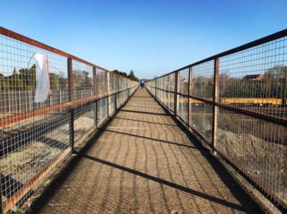 A cyclist crossing New Hinksey Bridge