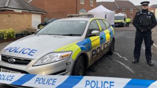 Police car and forensics tent on street in Costessey