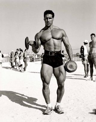A bodybuilder poses for the camera on Miama Beach