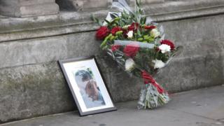 Una fotografía y un ramo de flores recuerda que el policía Keith Palmer murió en el ataque ocurrido este miércoles ante el Parlamento británico, en Londres.