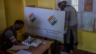 A Kashmiri nomad woman casts her vote in an enclosed chamber on the third phase of Indian general-election on April 23, 2019, in Anantnag, south of Srinagar, the summer capital of Indian administered Kashmir, India