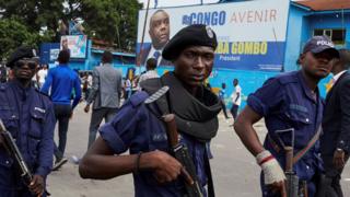 Police officers stand guard as supporters of DR Congo's defeated opposition candidate for the presidential election Martin Fayulu gather to attend a rally in Kinshasa, Democratic Republic of the Congo, 11 January 2019