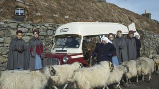 Call the Midwife characters surrounded by sheep