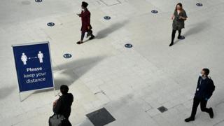 Commuters at a train station in London.