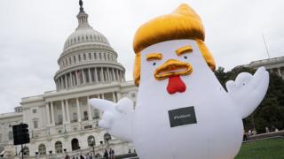 The adopted emblem of the march is an oversized inflatable chicken with blond hairstyle like Mr Trump