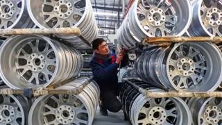 A factory worker with wheels in a Chinese factory