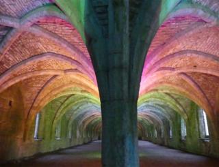 Colourful lights on a vaulted ceiling