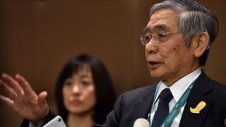 Governor of the Bank of Japan, Haruhiko Kuroda speaks to journalists.