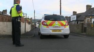 A policeman stands guard near the property on Tees Street