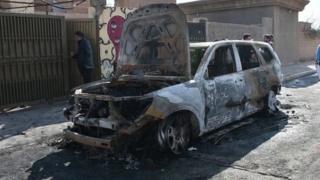 A burnt out car in al-Qaim, Iraq