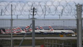 BA planes seen behind barbed wire fence